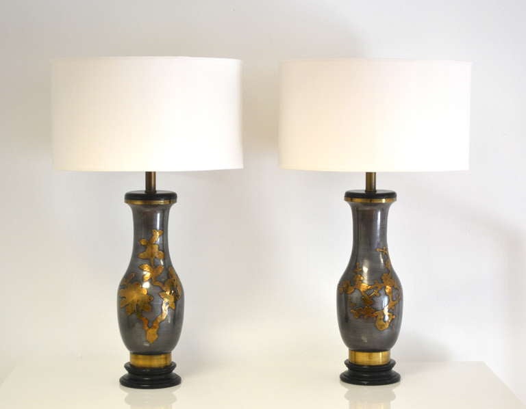 Elegant pair of Hollywood Regency style table lamps by Marbro Lighting, c.1950s - 1960s. These highly decorative gun metal  Asian Modern lamps are accented with raised brass decoration and mounted on ebonized bases. Shades not included.
Overall