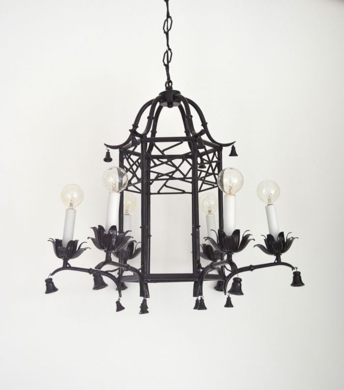 Hollywood Regency style faux bamboo pagoda chandelier with open fretwork design, six arms, and bell accents. c. 1970s
Please view our entire collection: 
(www.PatrickMoultney.com) or (www.center44.com/boutiques/patrickmoultney)
