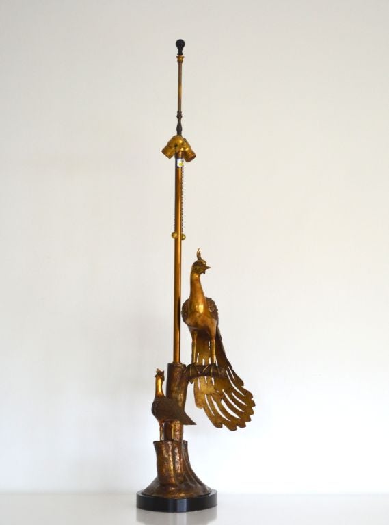 Artisan crafted Hollywood Regency style patinated brass sculptural peacock lamp on ebonized base by the Markoff brothers of the Marbro Lamp Company. c. 1950s.