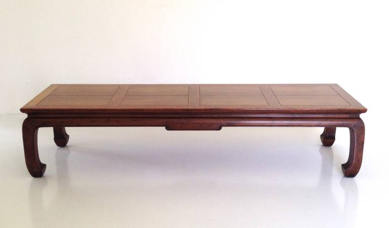 Striking coffee table by Michael Taylor for Baker, circa 1950s.  This stunning Mid Century Modern cocktail table in original excellent condition was part of Baker's Far East Collection, designed with inlaid rosewood and walnut panels.