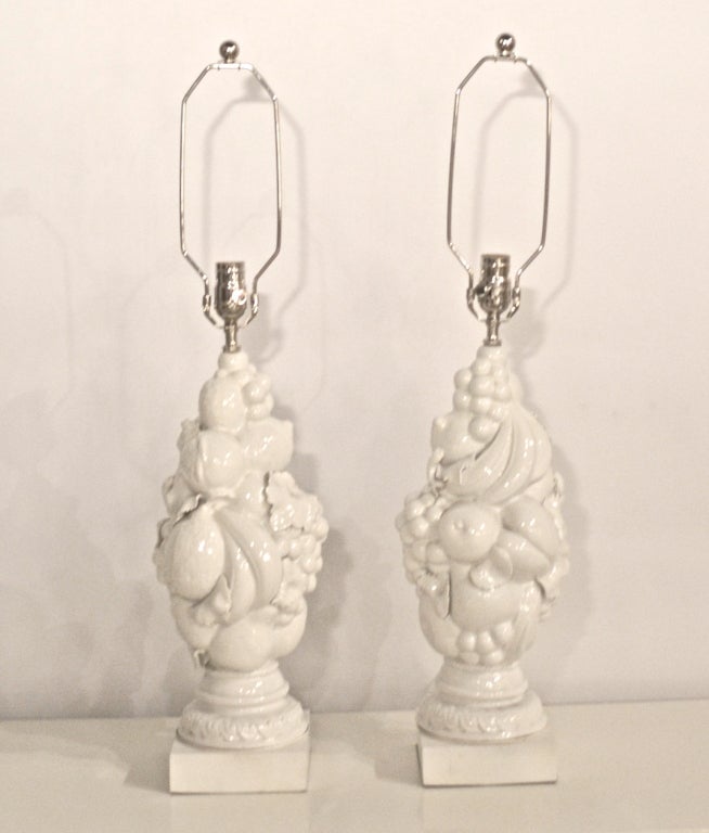 Pair of Mid Century Blanc de Chine topiary fruit form table lamps on white lacquered bases. These decorative hand thrown white glazed porcelain lamps are rewired with chrome fittings and white silk cords. c. 1950s - 1960s
(www.PatrickMoultney.com)