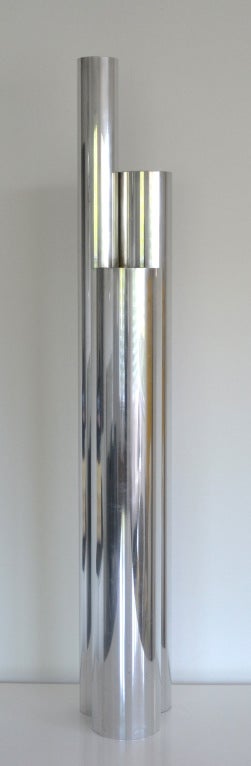Exceptional Mid Century Modern sculptural lamp with three differing heights of chrome tubes and matte black interiors. c.1970. This unique skyscraper inspired lamp works well as either a floor lamp or console/table lamp.