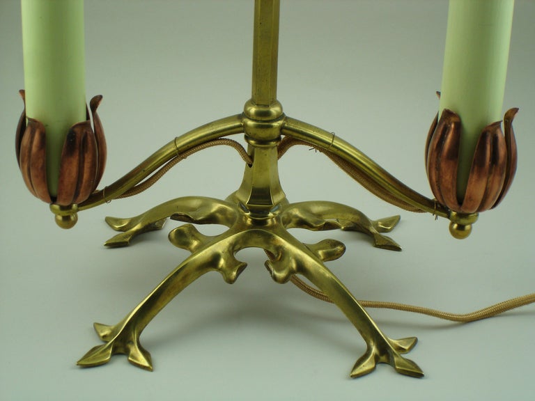 A w.a.s benson lamp in copper & brass candle sticks in wood