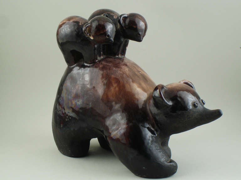 A terra cotta bear with two bear cubs on its back.
Partly glazed brown terra cotta, signed Primavera. This sculpture was made by the animal sculptor Wilfrid Prost, circa 1935.