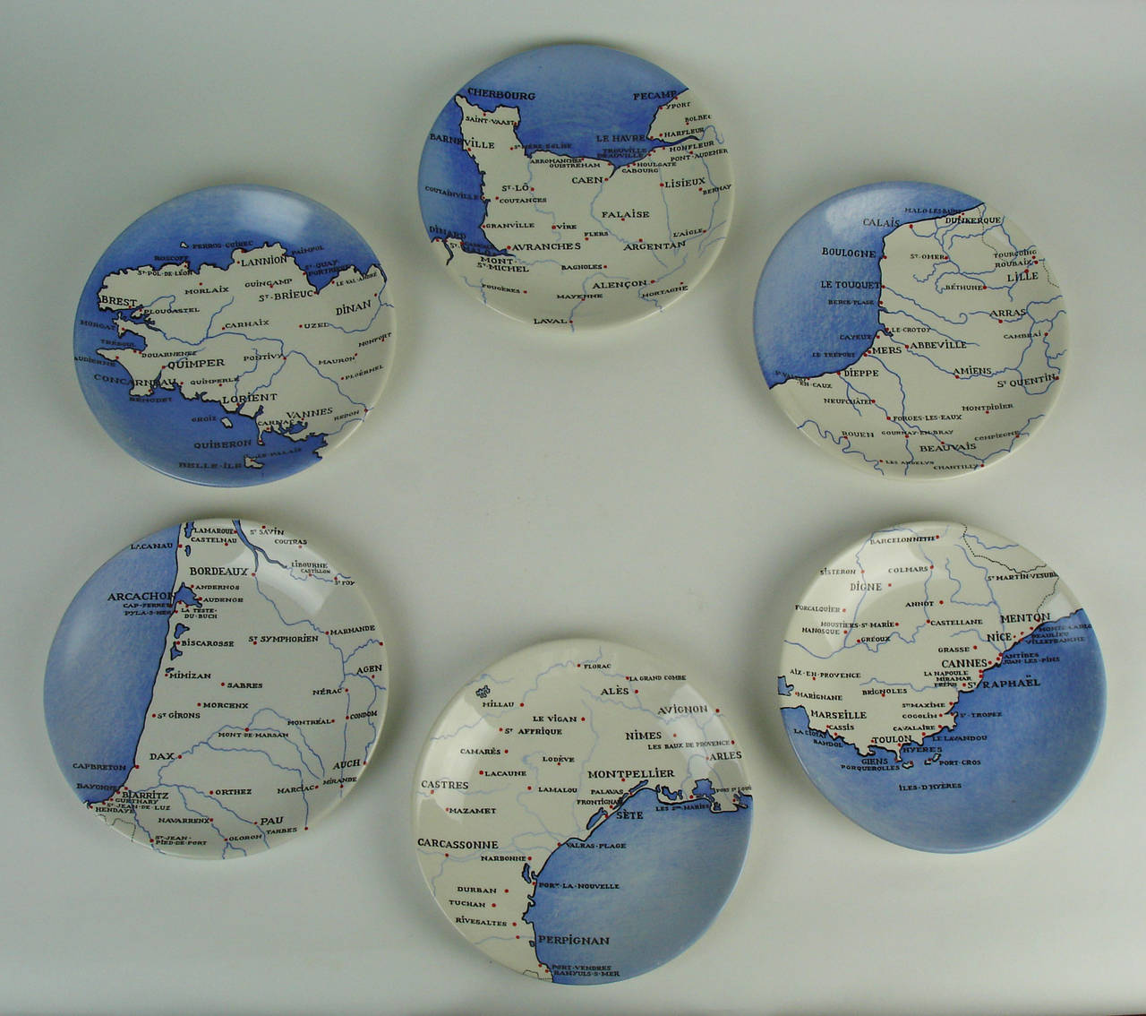 Six ceramic plates representing six different maps of the French coast. These plates were created by Colette Gueden for Primavera and manufactured by Keller & Guerin, circa 1950. Same plates p 478 in Primavera 1912-1972 atelier d'art du Printemps by