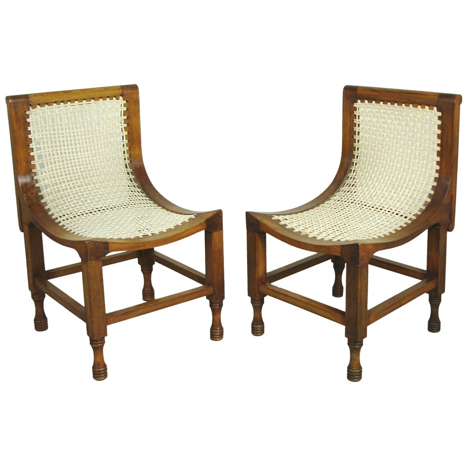 Two Thebes chairs in the style of Liberty