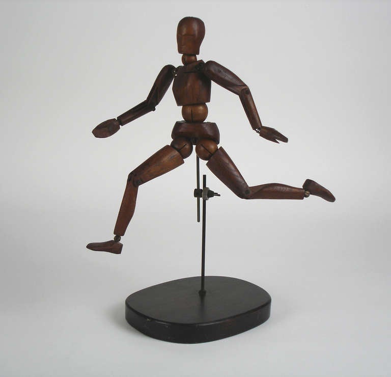 oak artist mannequin,articulated with metal pieces.Carved face.iron & mahogany support.