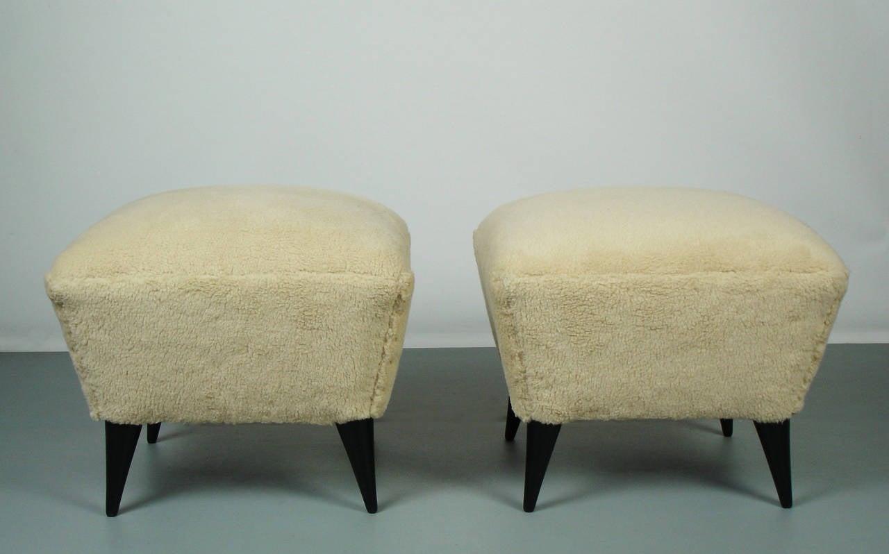 Two 1950's stools with four black lacquered feet,a new fabric.