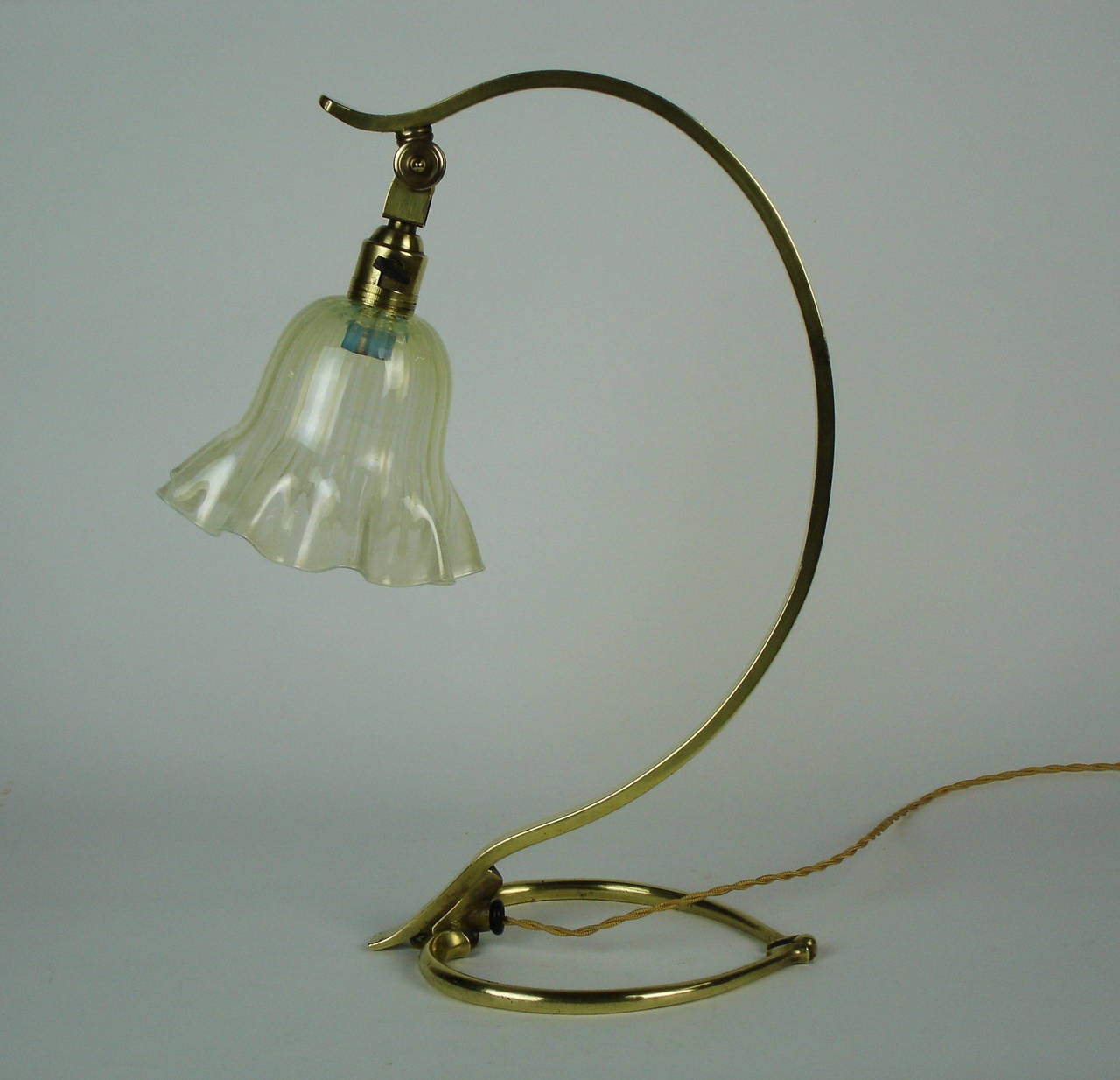 A brass table lamp designed by Benson with an opalescent Whitefriars glass shade.this lamp can also be used as a sconce .Unsigned.