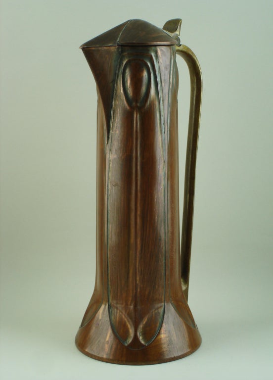 Jug with stylized motifs on the copper body,brass handle,stamped with the artist monogram & the editor name Edward Hueck