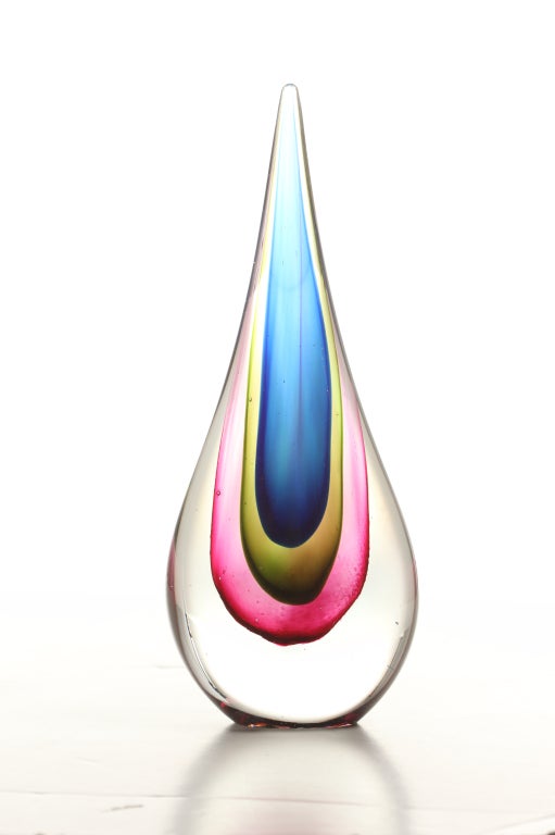 Radiant teardrop sculpture featuring nested layers of blue, yellow, pink, and clear glass. By Flavio Poli for Seguso.