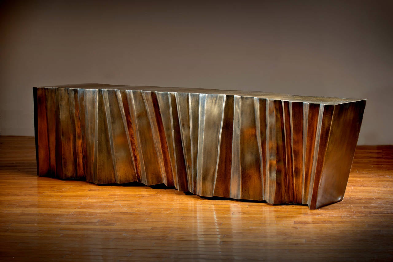 Cleaving Bench is a bronze sculptural furniture piece fabricated by Gregory Nangle.

The Gregory Nangle aesthetic explores what happens when geometry is interjected into nature. His work juxtaposes Minimalist geometry with forms or essences that