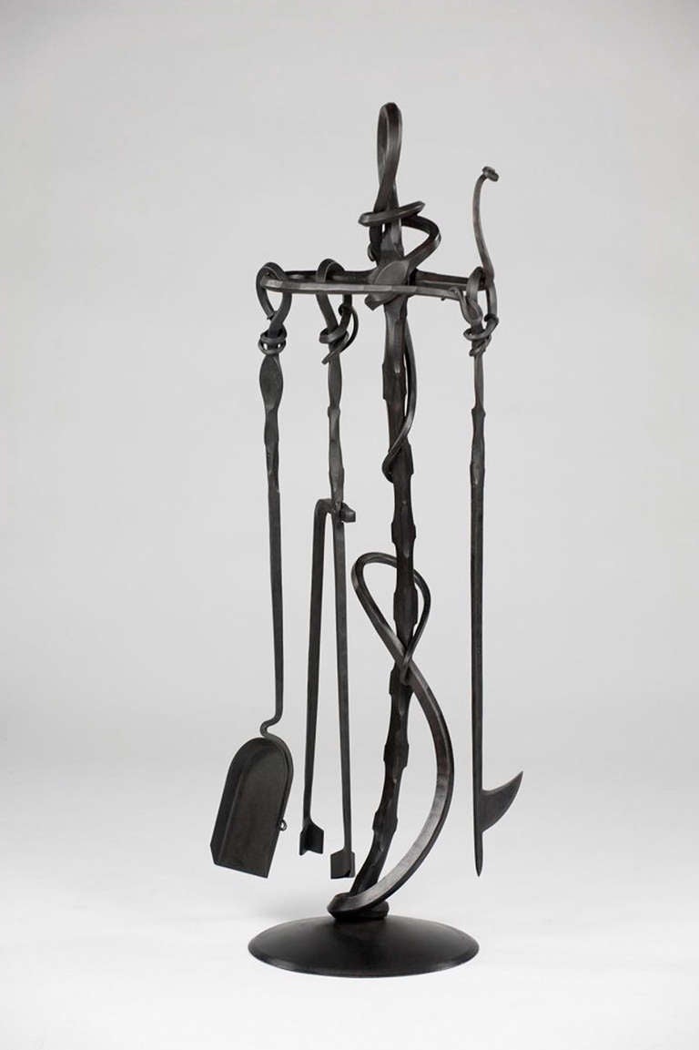"Forged Fireplace Tools" is a sculptural forged fireplace tool set created by designer/ maker Albert Paley.