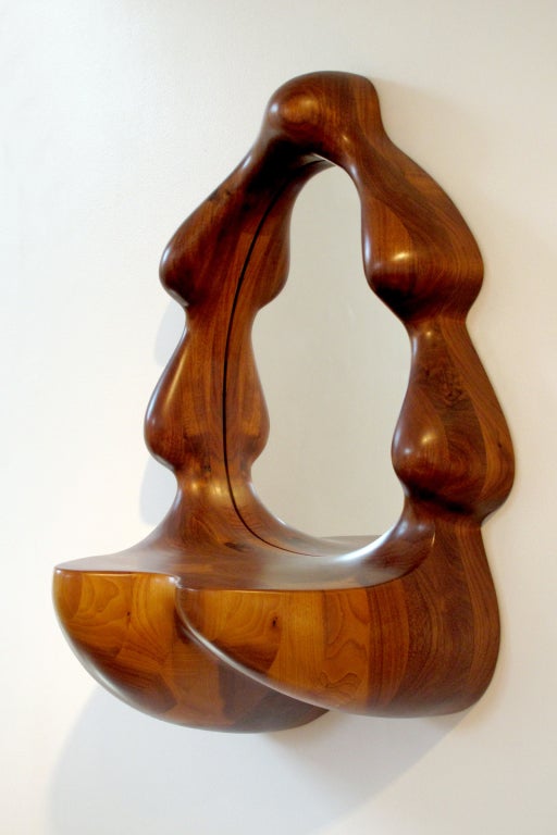 Unique sculptural mirror by Wendell Castle. Carved stack-laminated walnut. Signature and date to underside: WC 75.

Wendell Castle received a B.F.A. from the University of Kansas in Industrial Design in 1958 and an M.F.A. in sculpture, graduating