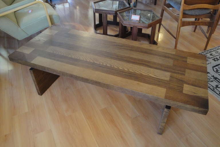 A 1960's Lane coffee table with a geometric pattern surface and a trestle style base. Strong architectural design elements. Fine original finish and condition.