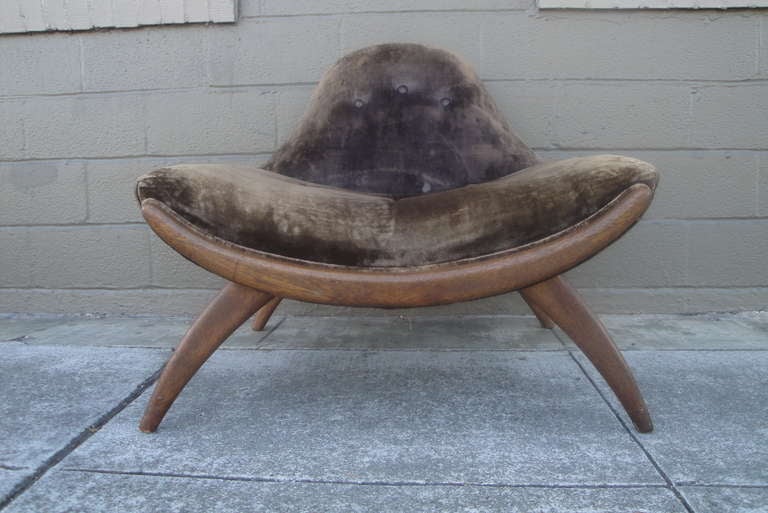 A sculpted walnut lounge chair by Adrian Pearsall.