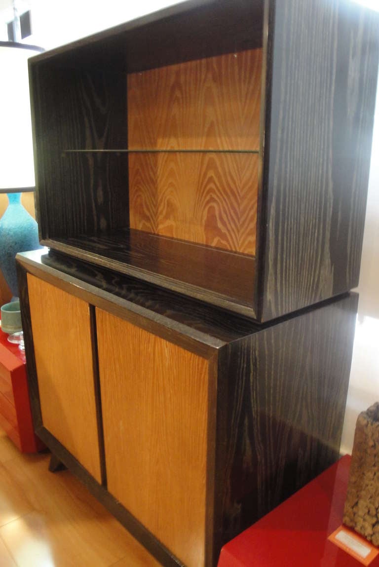 Cerused storage or china cabinet. Striking wood grain with contrasting blonde and black finishes with prominent angular design elements. Sliding glass removed for photography. Part of a 9 piece suite.