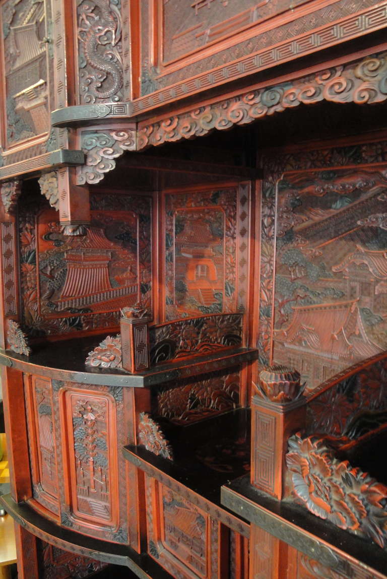 This incredible example of lacquer carving stands head and shoulders above nearly any piece it could be compared to, not only in terms of stature, but artistry as well. Standing over seven feet tall, this monumental display shelf was produced in