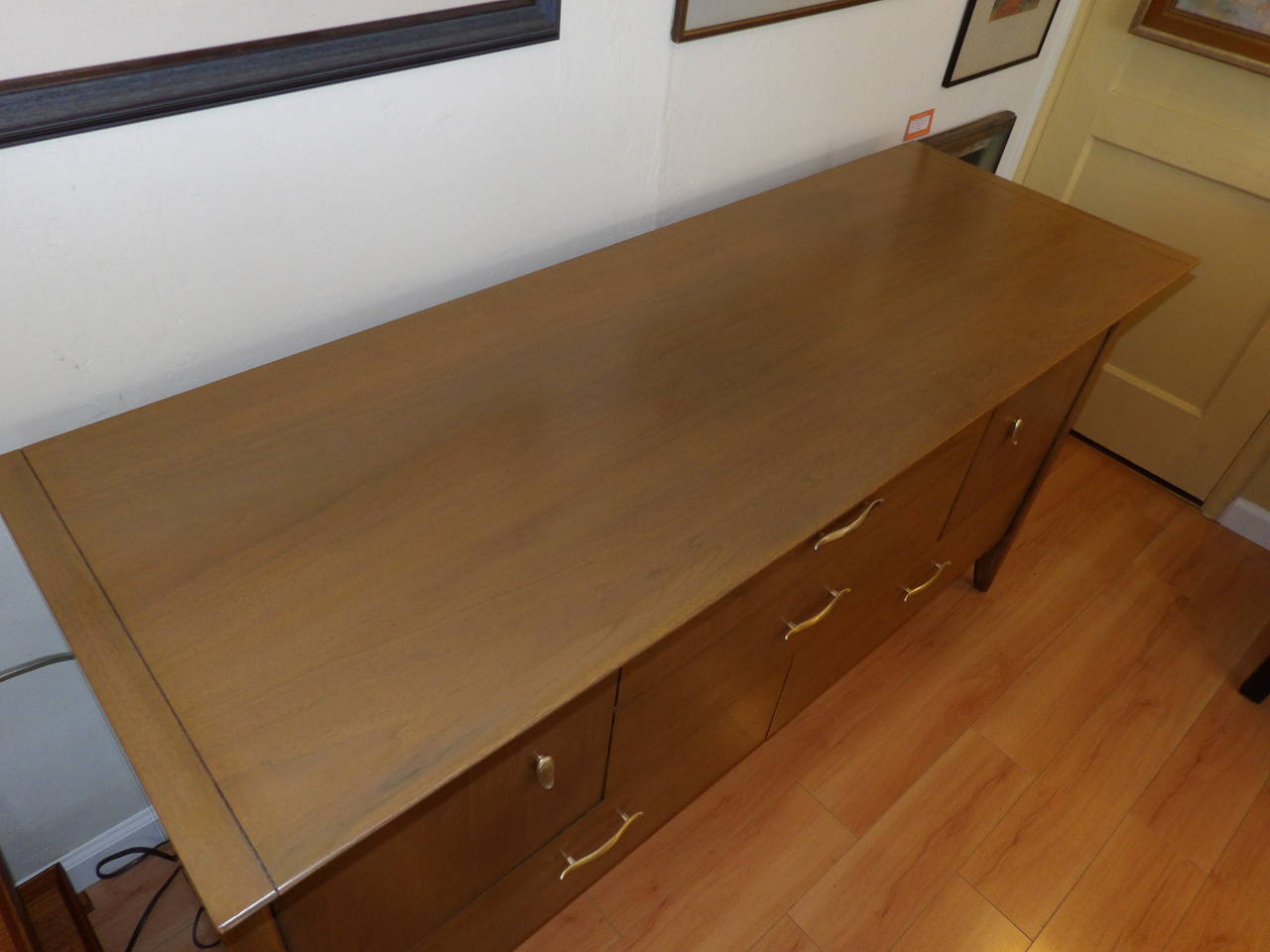 A walnut credenza designed by John Van Koert. The "Profile" line produced by Drexel Furniture in the 1950s. Very good original finish with a refinished top surface.