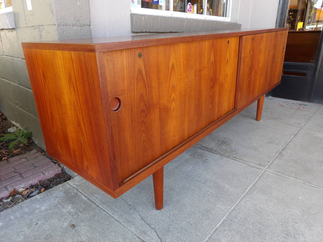 Important teak Danish Modern credenza designed by Hans J. Wegner. Sliding doors with adjustable shelves and six interior drawers.