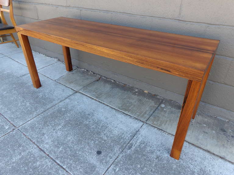 Exceptional figured wood grain on this rosewood Danish Modern Parsons console table. Excellent original finish and condition. 