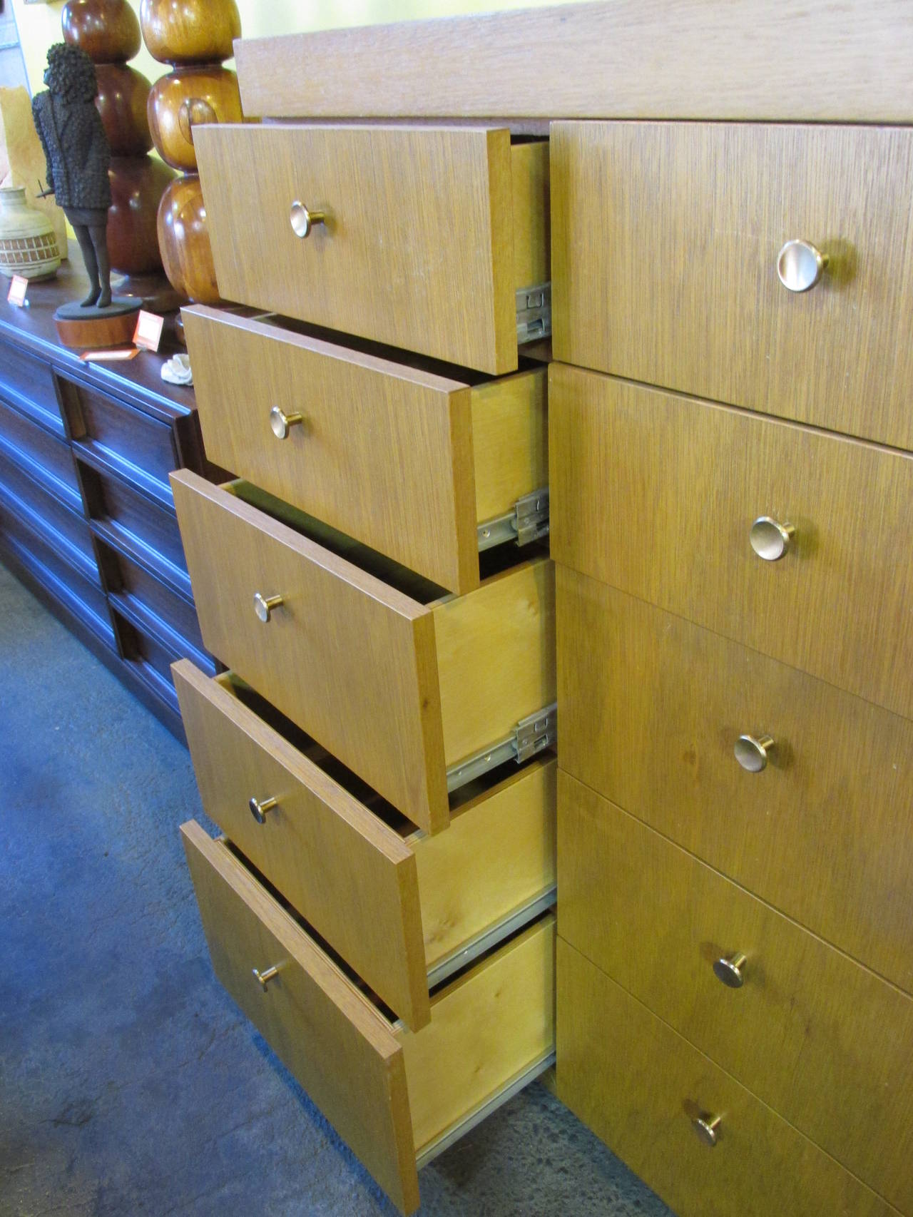 A John H. Howe design inspired by Frank Lloyd Wright. A golden mahogany tall ten-drawer dresser. Original hardware and finish. Steel drawer glides offer exceptionally smooth drawer open and close. Originally from the estate of John H. Howe and his