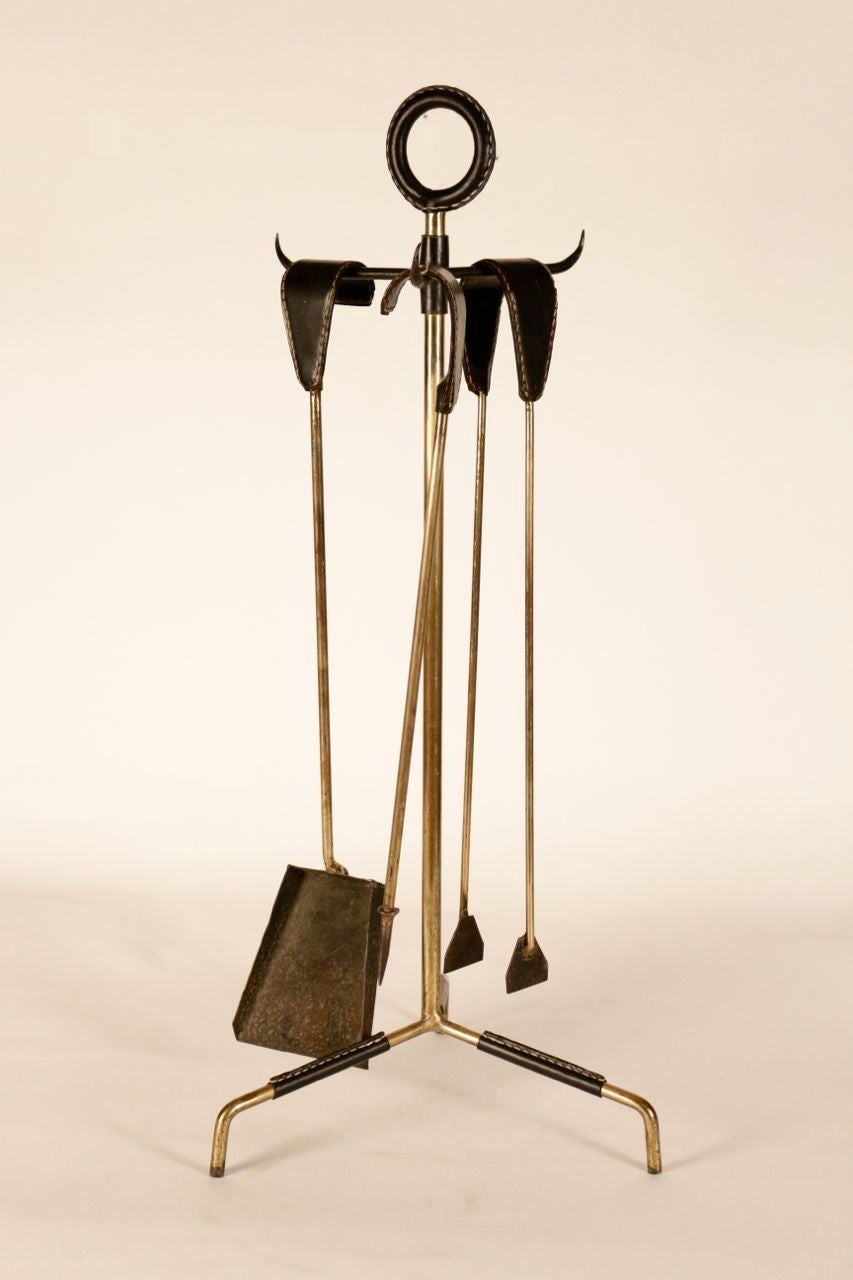 Jacques Adnet tools in brass and stitched leather.
