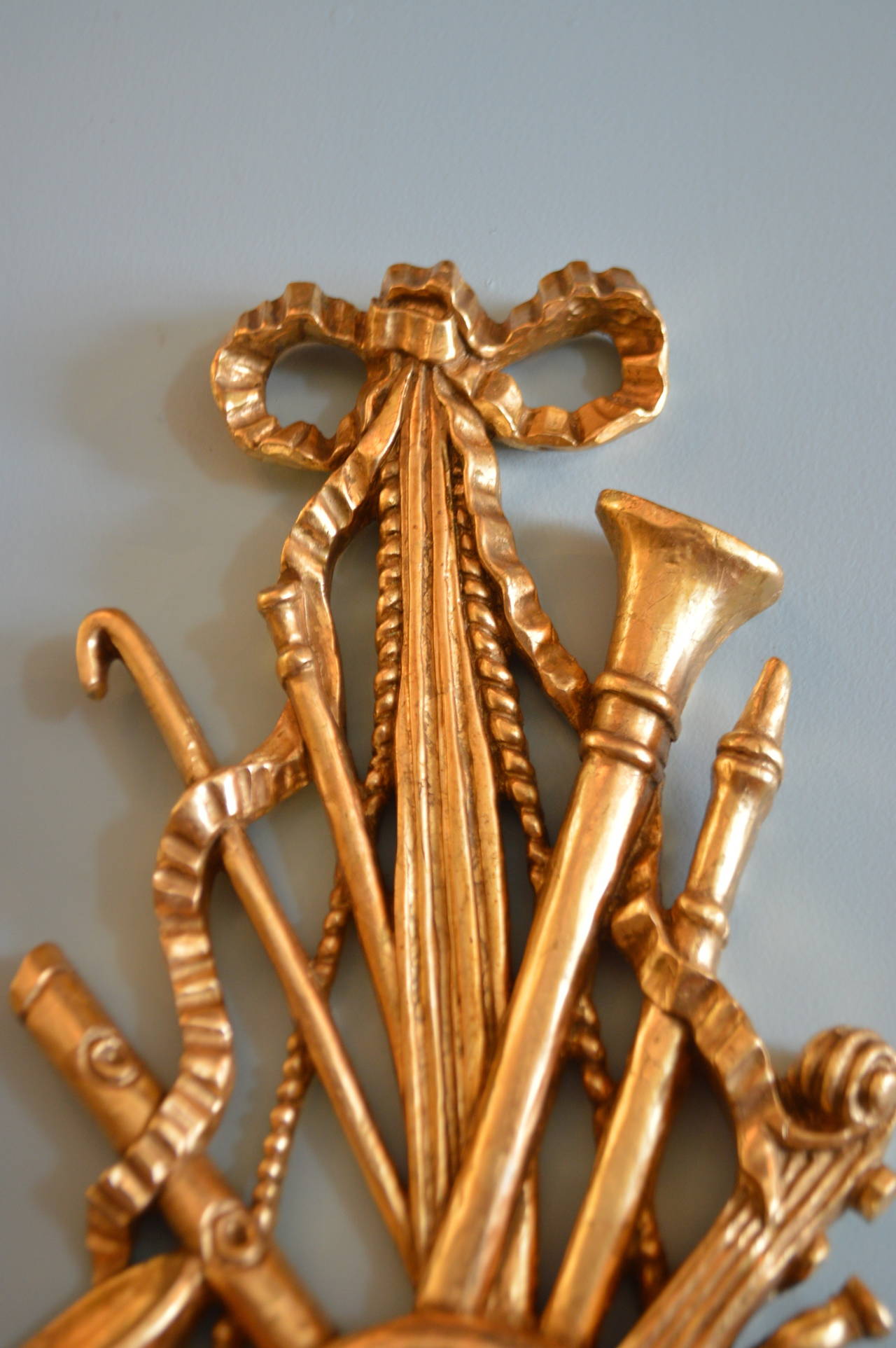 Louis XVI style unusual pair of  hand carved musical theme wall decoration, it has been leaf gilded over wood.