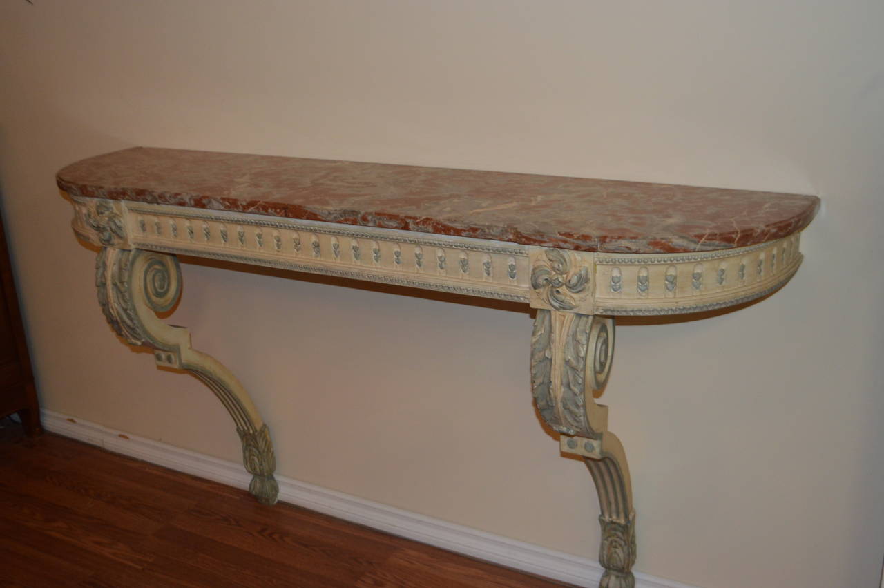 Beautiful and elegant hand-carved console, wood tone are cream and robin egg blue with the original marble top.