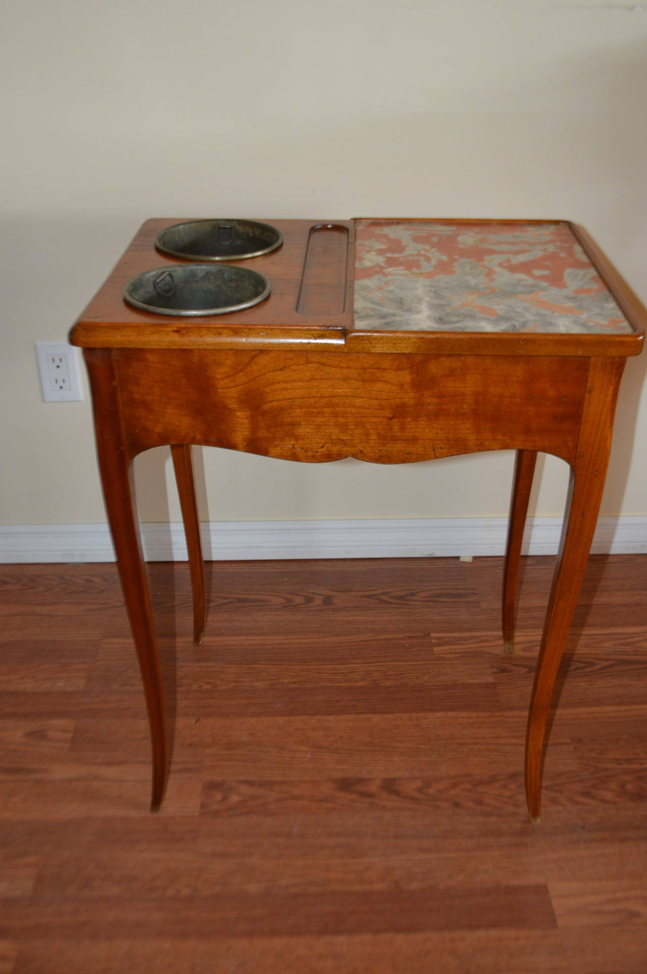 Mid-19th century, peg constructed cherrywood wine tasting table with two metal baskets to hold bottles and marble top for tasting. It has one drawer.