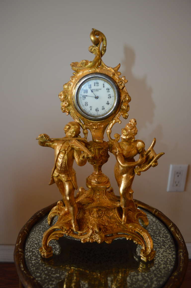 Lovely decorative gilded over metal clock with a musical theme.It was made by
New Heaven Clock Co. U.S.A. established in 1857.