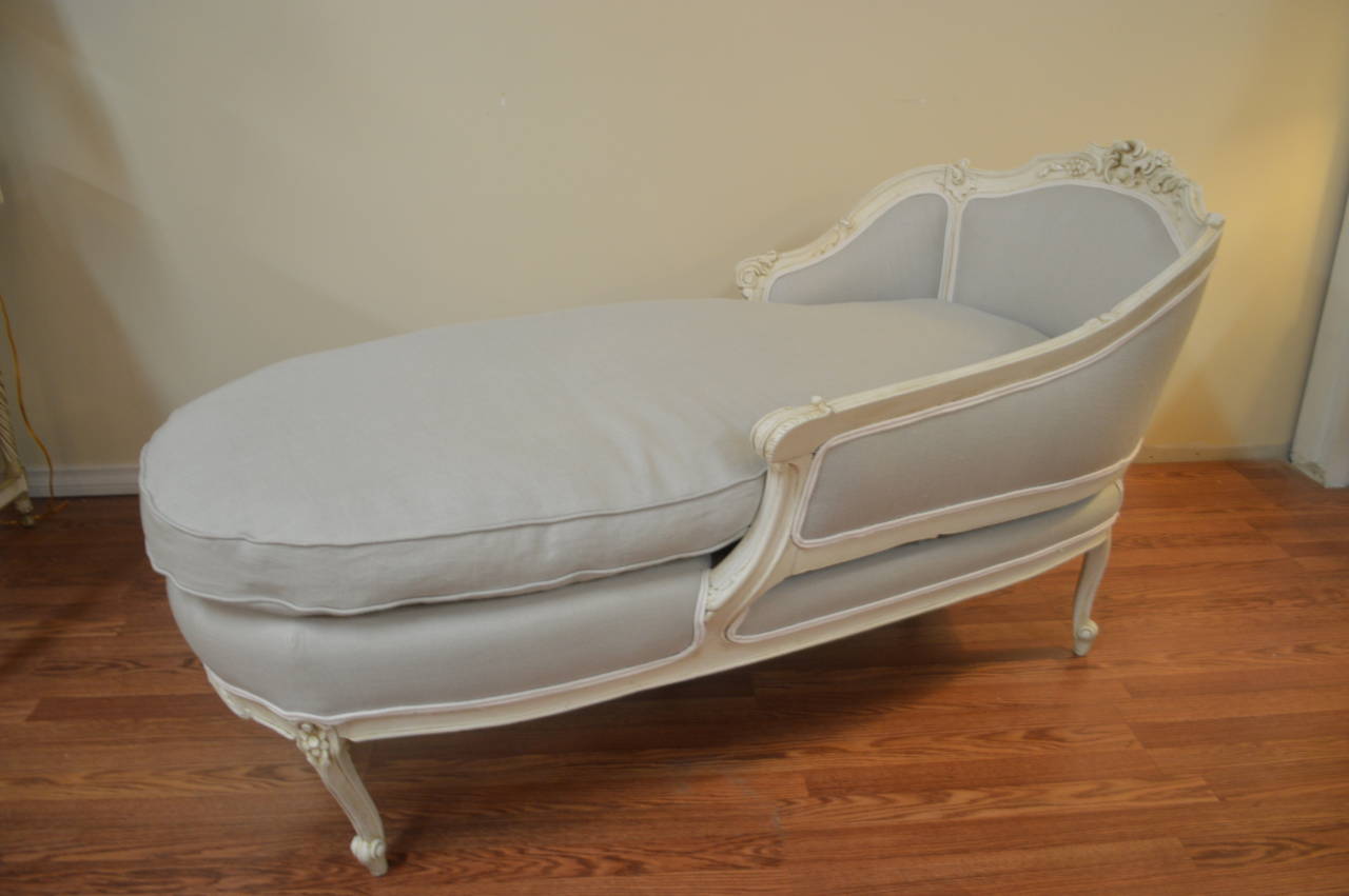 Louis XV style hand-carved frame is circa 1890. The chaise has been newly upholstered in a pale aqua linen with white linen piping. The seat cushion is a mixture of dawn and feather and the original spring have been used. It is a very comfortable