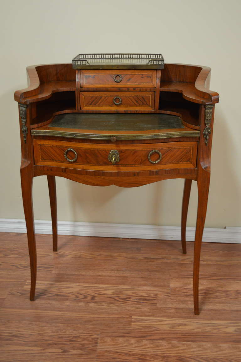 Louis XV style with exceptional inlay pattern butler's desk..
There are 3 drawers, one large and two small above the table. There is a marble top above the small drawers with a bronze gallery. The writing table in leather can be pulled out. The