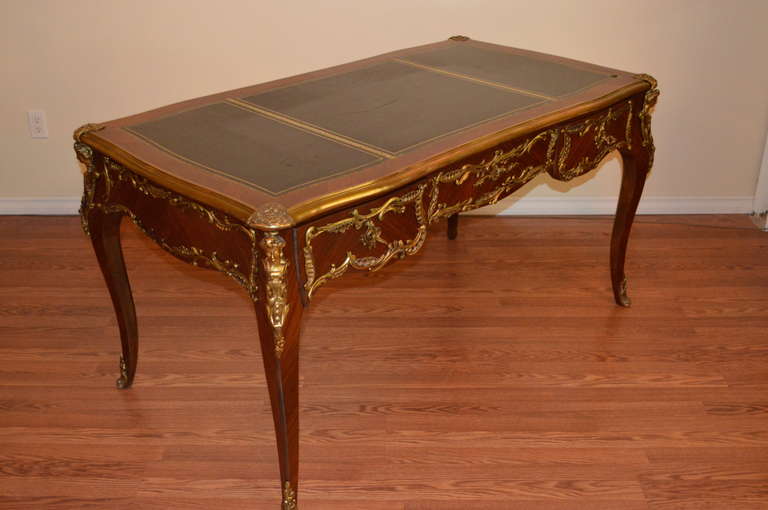 Louis XV style desk with bronze figural details. at 1stDibs