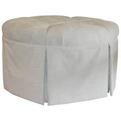 Upholstered and tuffted Ottoman or coffee table.