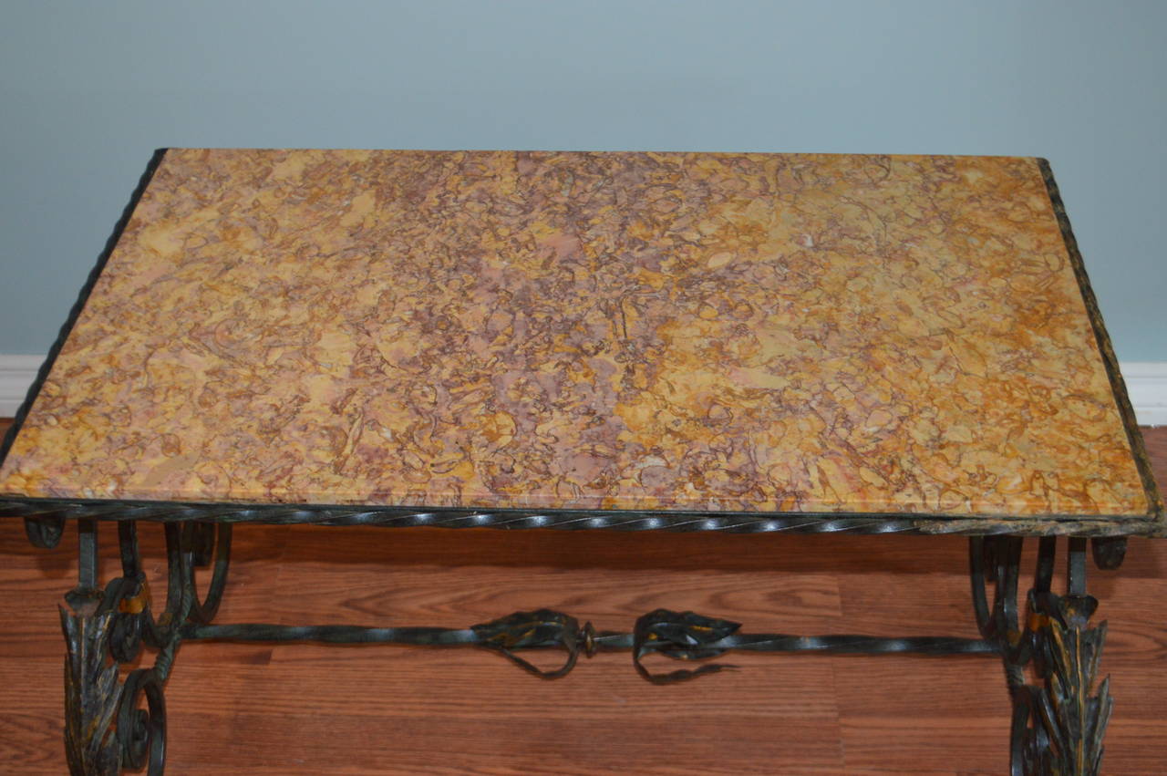 Lovely hand forged wrought iron coffee table with the original marble top.
