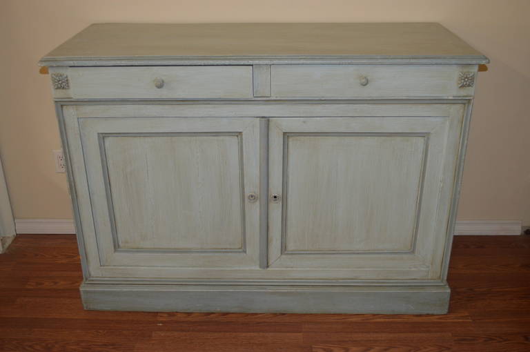 Louis Philippe period painted in two tones of blue, with two drawers and two doors with shelved compartment. The cabinet has been painted over solid oak.