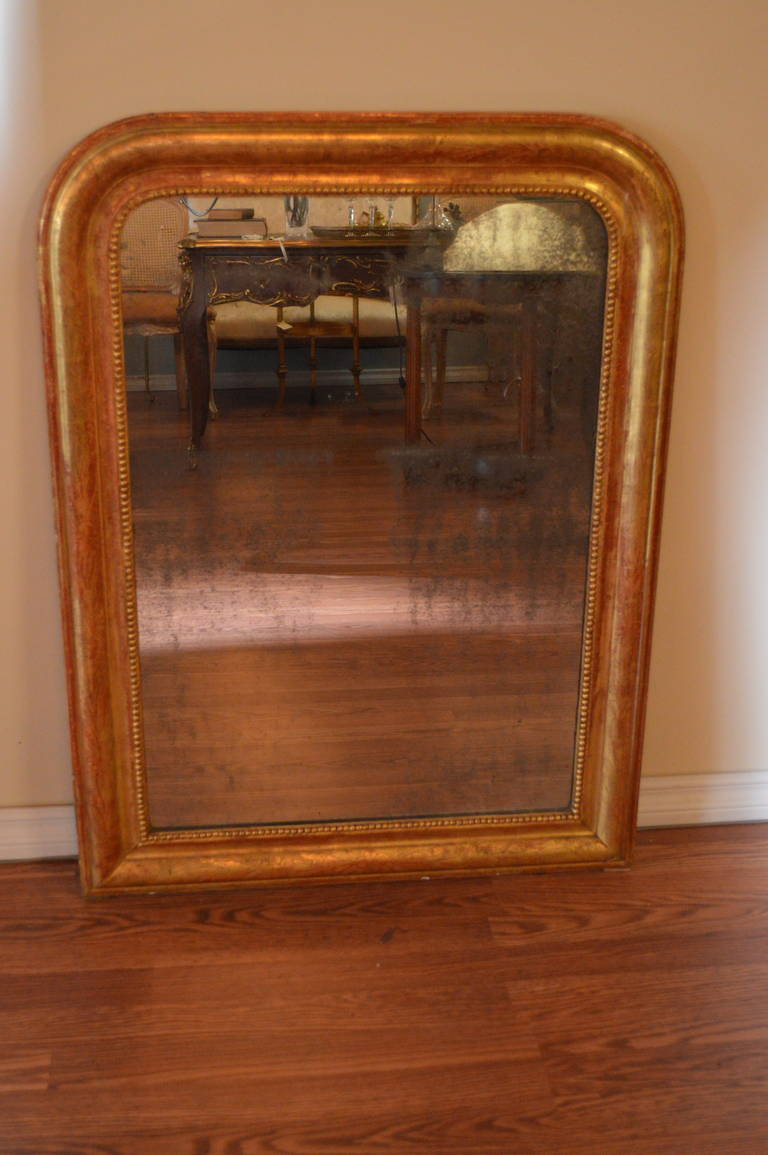 Louis Philippe period gilded mirror, mirror's silver backing strongly exposed.
There are lovely floral etching all around the frame, typical of the Louis Philippe
Period frames.