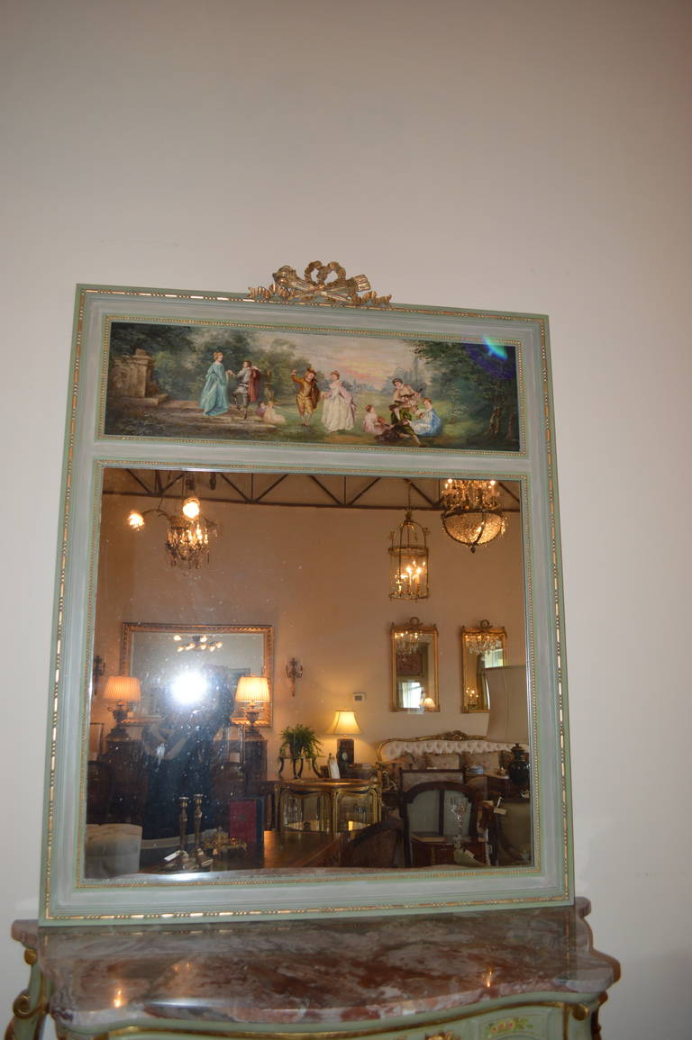 Lovely Louis XVI style painted trumeau mirror. The oil painting is very well executed and painted on a board, signed Troisgrois. The frame is painted in two tones of green with some gilt accent.