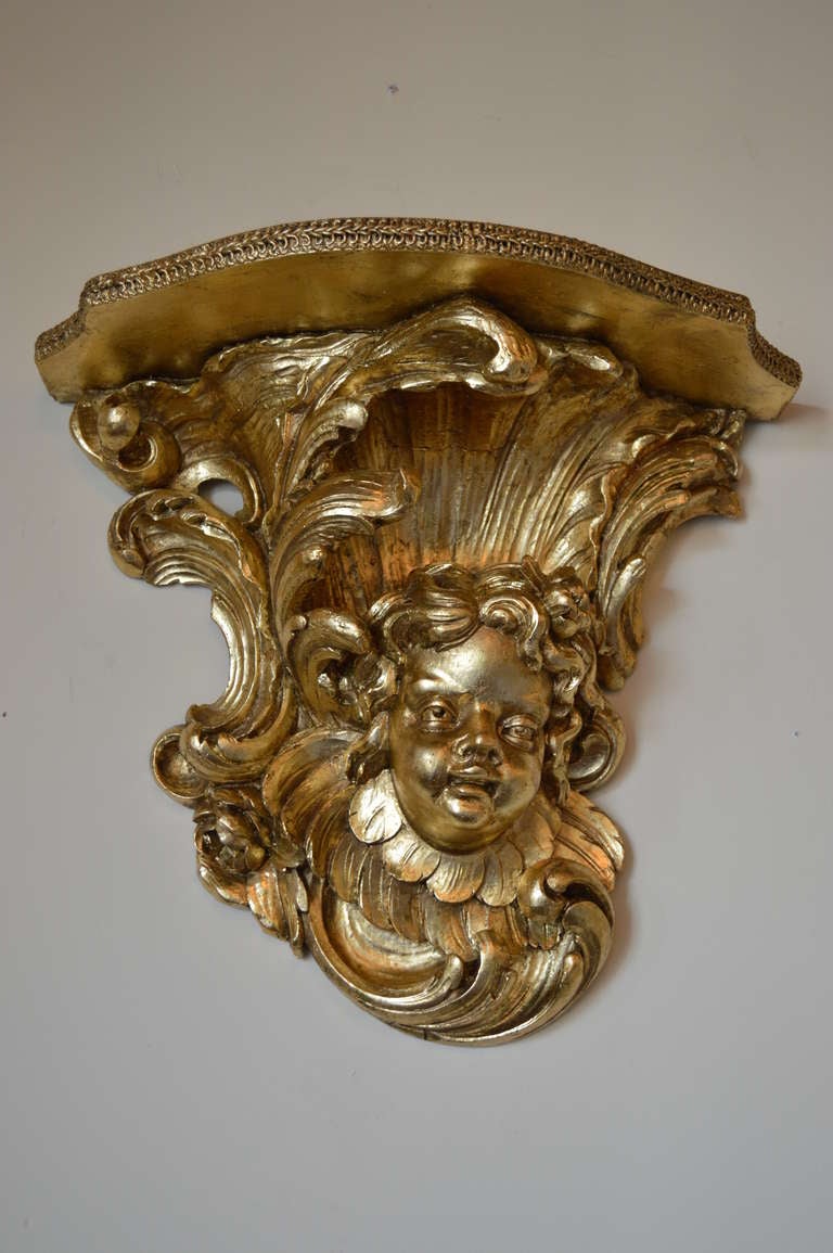 Heavily carved and leaf gilded over stucco decorative shelf.