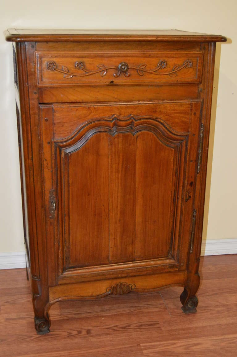 Louis XV style walnut jam cupboard, it has a lovely patina. The bronze hardware is original to the cabinet.