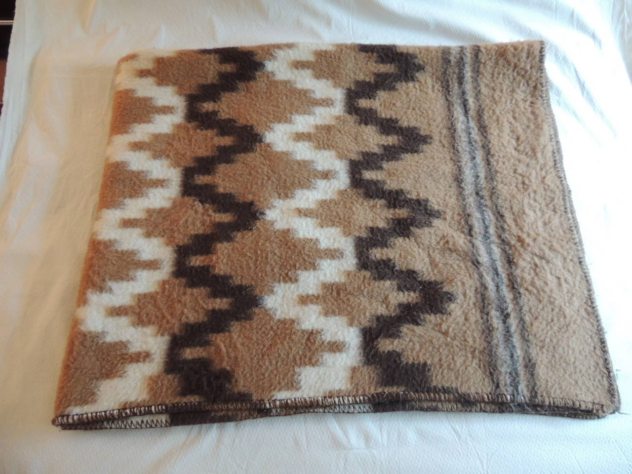 Large vintage modern design Alpaca blanket. Reversible design in shades of white, brown and camel. Great blanket or throw. Hand-stitched all around edges.