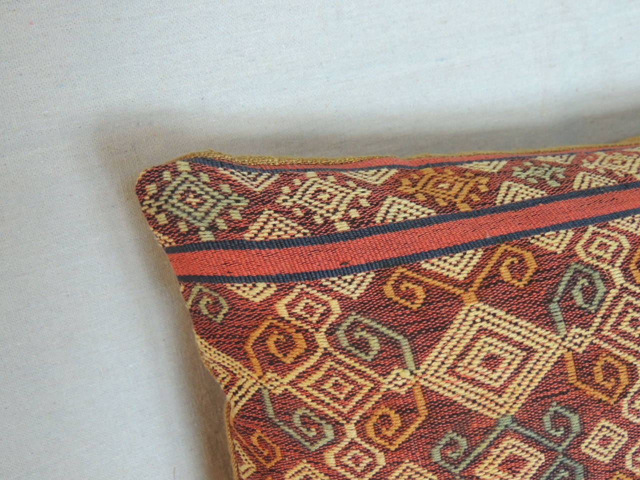 Weave texture weft- Ikat bolster pillow in shades of orange, yellow and red. Strie linen backing.