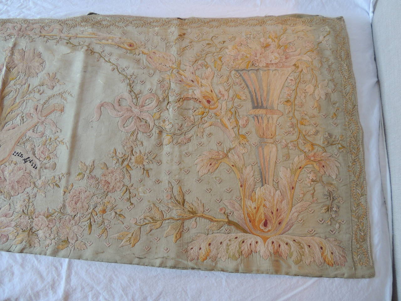 Embroidery panel depicting music instrument in the center medallion and blooming flowers all-around. Silk and linen on silk background textile. Soft shades of green, yellows, pink and brown.
