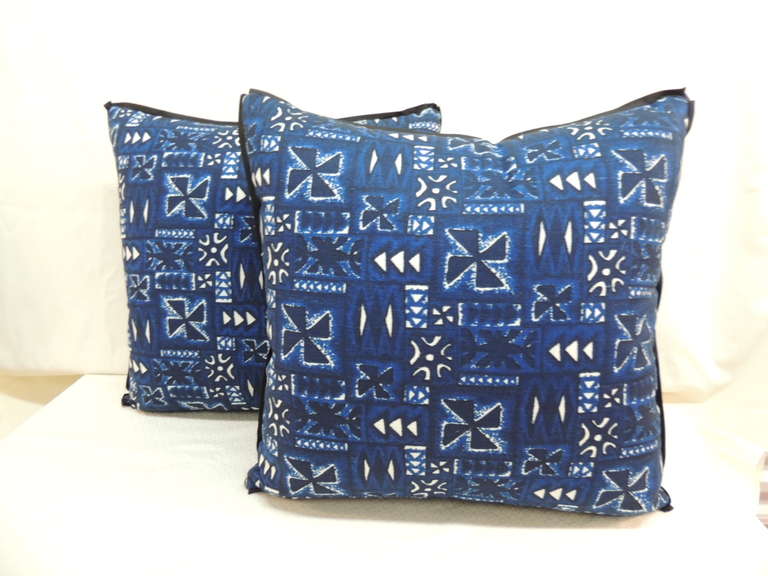Pair of Vintage 1960's African hand blocked linen pillows in Indigo blue, black and white details. Flat black trim all-around.  Fabric on both side of the pillow.