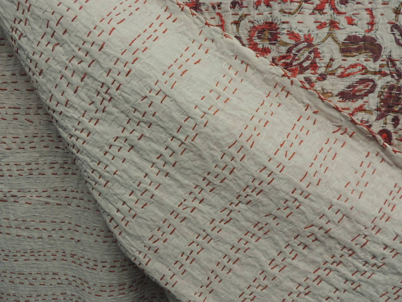 Pink and white floral hand-quilted blanket, patchwork design, individual pieces of hand-blocked textiles have been stitched together to create this large (king size) blanket/coverlet. Solid white backing with red stitching up-down and hand-stitched