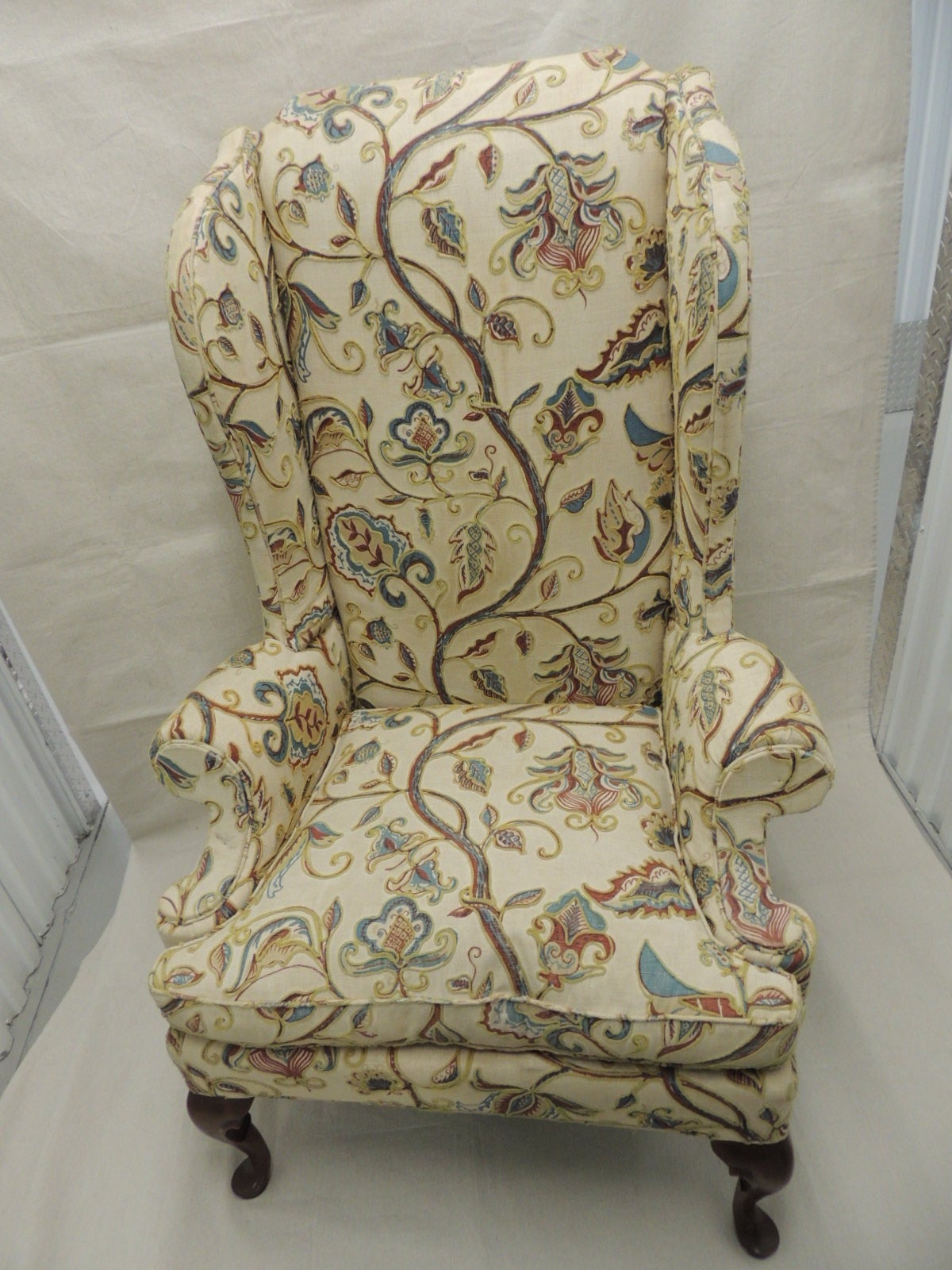 Fantastic George I style embroidery linen crewel work upholster wing chair (original upholstery). The silk antique moss green velvet back was recently done. The new loose cushion filler (zipper) is feather/down. Rolled arm with curved back. In