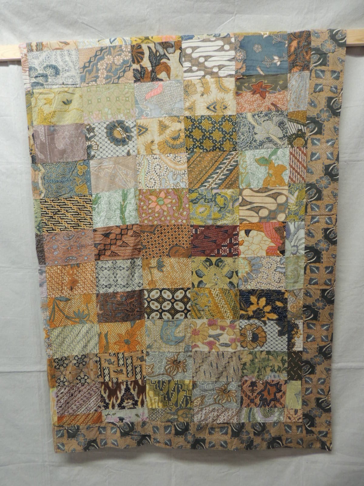 Offered by the Antique Textiles Galleries:
Large vintage Indian Batik patchwork blanket double sided small pieces of vintage and antique batik floral and tribal pattern textiles. Reversible blanket. Very colorful.  In shades of yellow, green, blue,