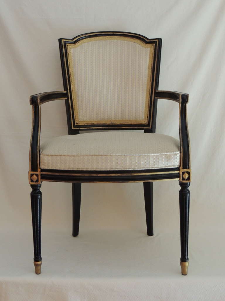 Vintage pair of Louis XVI Maison Jansen arm dining chairs, ebonized black paint and gold details. Upholster in a beige tone-tone basket weave fabric and decorative silk trim. (Not the original upholstery.) No chips or marks on fabric or finish.
Arm