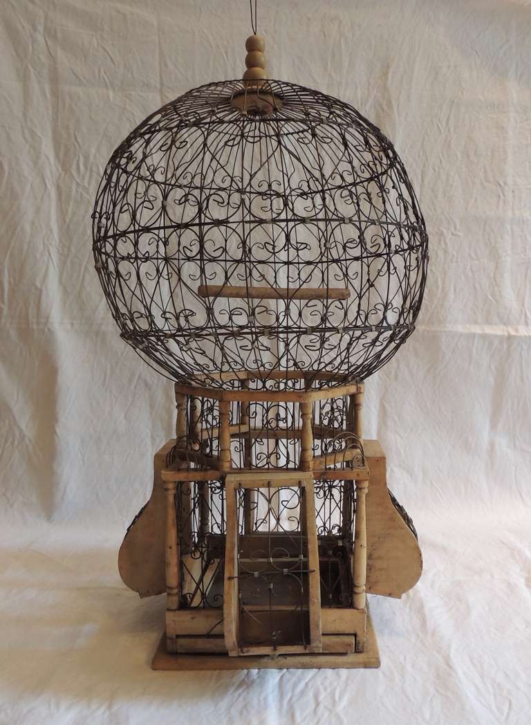 Large vintage French  wire and wood birdcage, amazing wire-work, pull-out tray, and top finial with hanging wire.